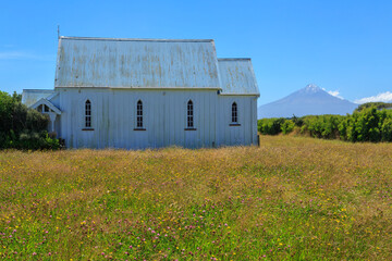 The historic St. John's Anglican Church (1893) in Otakeho, New Zealand, with Mount Taranaki in the background