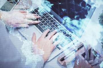 Double exposure of woman hands typing on computer and business theme hologram drawing. Success...