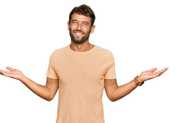 Handsome young man with beard wearing casual tshirt smiling showing both hands open palms, presenting and advertising comparison and balance