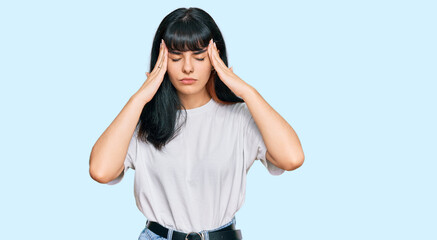 Young hispanic girl wearing casual clothes with hand on head for pain in head because stress. suffering migraine.