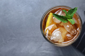 Delicious iced tea in glass on grey table, top view. Space for text