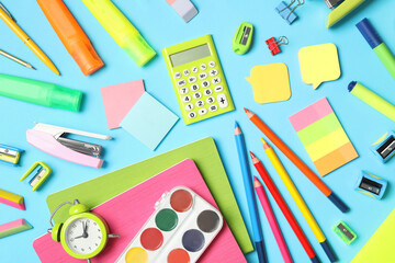 Different stationery on light blue background, flat lay. Back to school