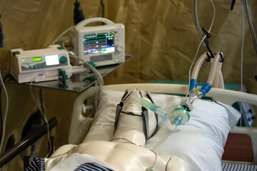 Plastic dummy in an oxygen mask of artificial lung ventilation. The practice of military doctors in a field hospital. Instructions for providing first aid to the victim during hostilities