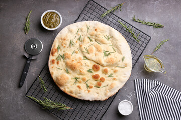 Flat lay composition with focaccia bread on grey table