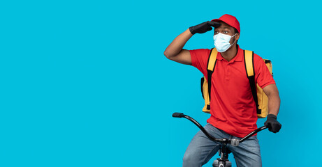 African american delivery guy in medical mask looking away