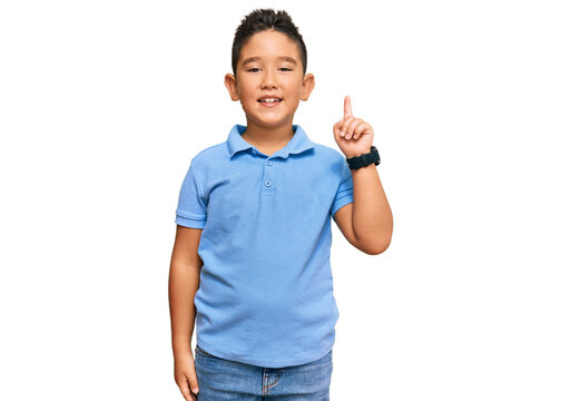 Little Boy Hispanic Kid Wearing Casual Clothes Showing And Pointing Up With Finger Number One While Smiling Confident And Happy.