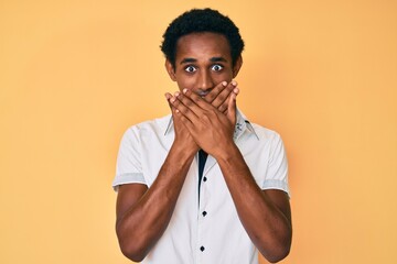 African handsome man wearing casual shirt shocked covering mouth with hands for mistake. secret concept.