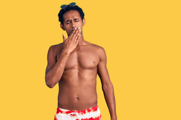 African handsome man wearing swimsuit and sunglasses bored yawning tired covering mouth with hand. restless and sleepiness.