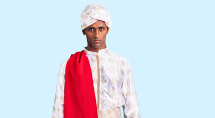 African handsome man wearing tradition sherwani saree clothes skeptic and nervous, frowning upset because of problem. negative person.