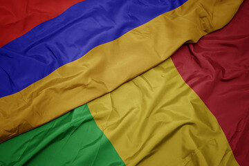 waving colorful flag of mali and national flag of armenia.