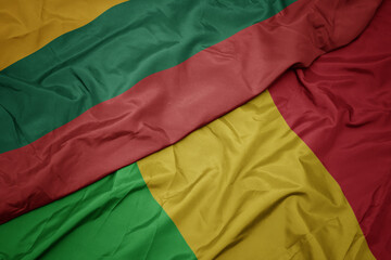 waving colorful flag of mali and national flag of lithuania.