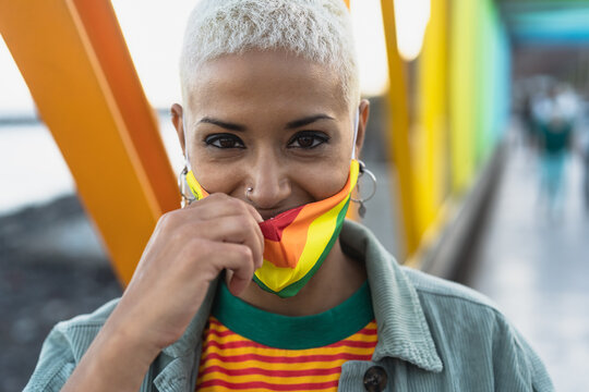 Young woman wearing gay pride mask symbol of Lgbtq social movement