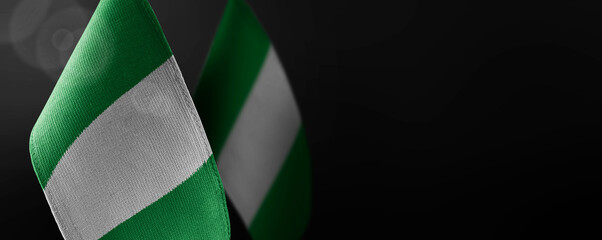 Obraz premium Small national flags of the Nigeria on a dark background