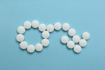 Male sign with bent arrow of white pills symbolizing potency problems on light blue background,...