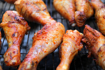 
marinated chicken drumstick is fried over coals with spices and herbs.