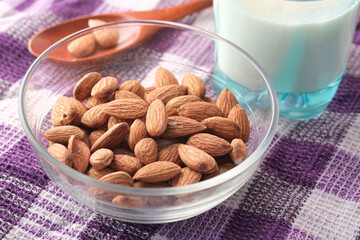 almond nut and milk on table cloth, close up 