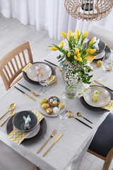 Beautiful Easter table setting with festive decor indoors, above view