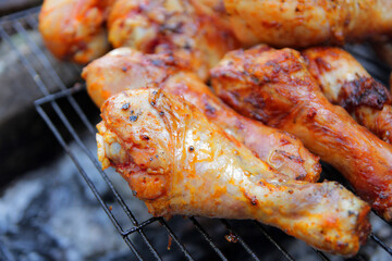 
marinated chicken drumstick is fried over coals with spices and herbs.