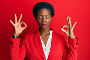 Young african american girl wearing business clothes relax and smiling with eyes closed doing meditation gesture with fingers. yoga concept.
