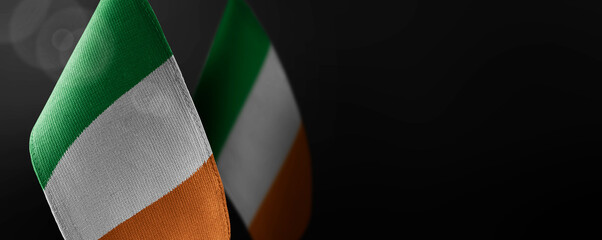 Small national flags of the Ireland on a dark background
