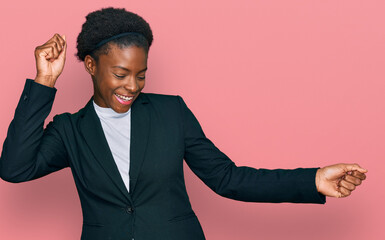 Young african american girl wearing business clothes dancing happy and cheerful, smiling moving casual and confident listening to music