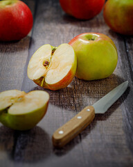 still life with apple and knife on wooden table