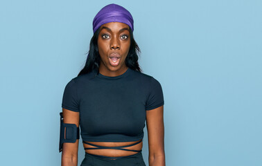 Young african american woman wearing sportswear scared and amazed with open mouth for surprise, disbelief face