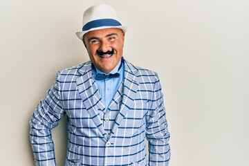 Mature middle east man with mustache wearing vintage and elegant fashion style with a happy and cool smile on face. lucky person.