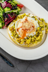 Avocado Sandwich with Poached Egg. Chopped avocado and egg on toasted bread for healthy breakfast or snack.