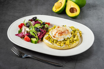 Avocado Sandwich with Poached Egg. Chopped avocado and egg on toasted bread for healthy breakfast or snack.