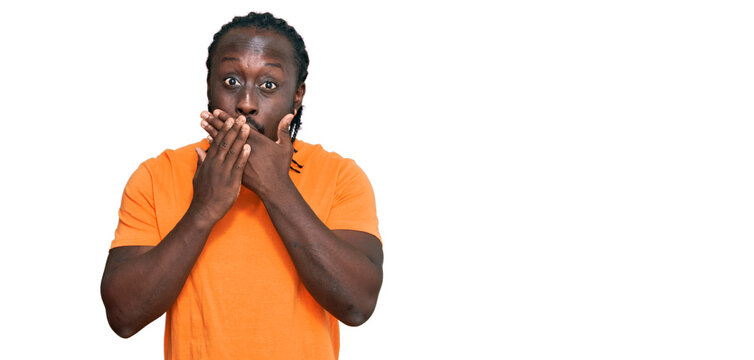 Handsome young african american man wearing casual clothes shocked covering mouth with hands for mistake. secret concept.