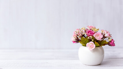  pink rose flower on wood shelf white background.   copy space for text. Still life and Lifestyle Concept