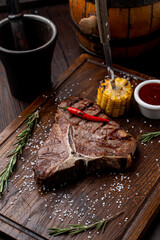Huge and juicy t-bone steak on a wooden board, cloose up shot