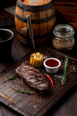 Sirloin grilled corn  on a dark wooden board, recipe magazine photo