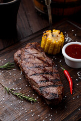 Black angus steak on a dark wooden board, beautiful magazine photo