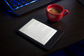 The person is reading the digital book while drinking coffee.