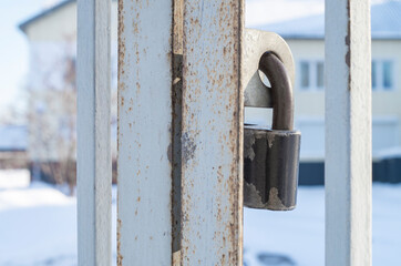 Security concept: old rusty metal padlock on light background, copy space