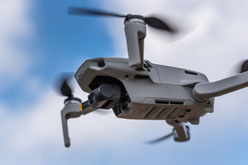 青空をホバリングするドローン