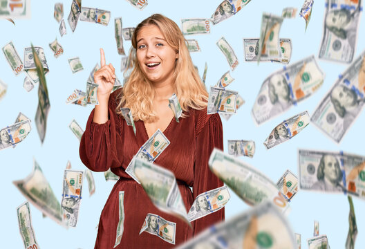 Young blonde girl wearing casual clothes pointing finger up with successful idea. exited and happy. number one.