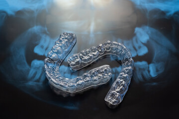 Transparent bite correction trays and x-ray of the jaw. Orthodontist equipment