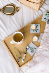 Cup of tea on a tray in the bedroom with mirror