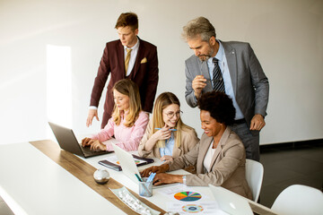 Multiethnic group of business people working together and preparing new project on a meeting in office