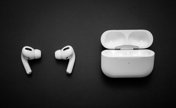 Belgrade, Serbia - January 2021. Apple AirPods Pro on black background. Wireless headphones and charging case