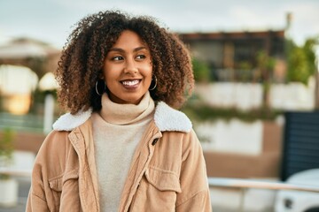 Young african american woman smiling happy standing at the city.