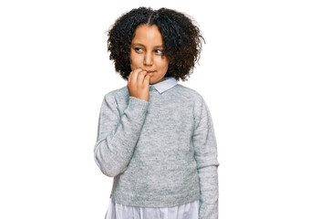 Fototapeta na wymiar Young little girl with afro hair wearing casual clothes looking stressed and nervous with hands on mouth biting nails. anxiety problem.