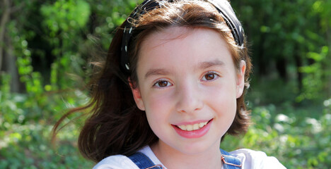 
portrait, girl smiling and posing in spring forest.