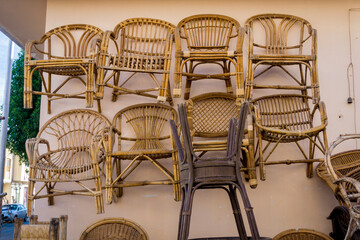 Old chairs of natural woven straw on the wall