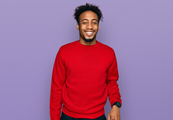 Young african american man with beard wearing casual winter sweater with a happy and cool smile on...