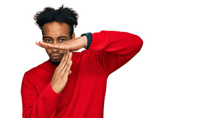 Young african american man with beard wearing casual winter sweater doing time out gesture with...