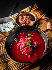 Beetroot soup Traditional Ukrainian or Russian borscht with sour cream in a bowl on wooden table